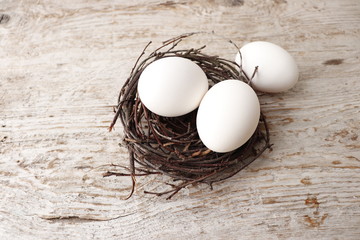 White chicken eggs in the nest. Three eggs.
