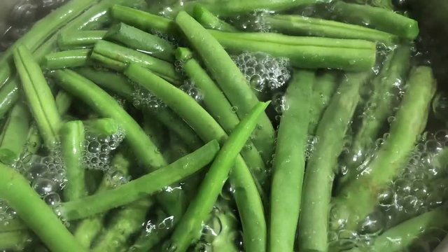 Close up of boiling green string beans in hot water.