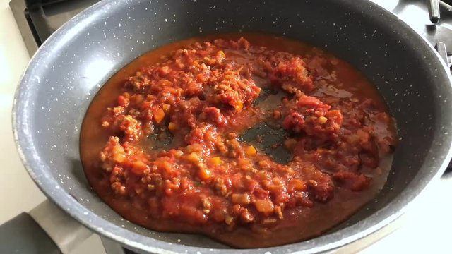 Time lapse of cooking ragù, a typical Italian sauce for pasta with tomato and meat.
