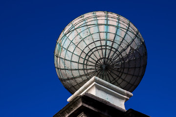 Concrete globe isolated blue sky