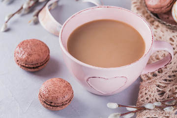 Pink coffee mug with sweet pastel french macaroons and pussy willow