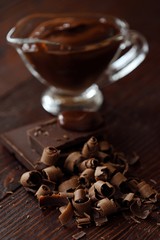 Delicious hot chocolate in glass on a brown background