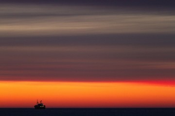 Fototapeta premium Fishing-boat during sunset