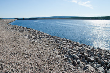 Fototapeta na wymiar Water reservoir, dam of Porjus hydropower plant, Lapland, Jokkmokk, Sweden