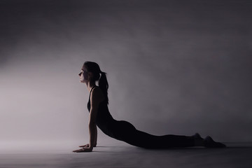 woman doing physical exercises for a healthy posture and a slim figure, relaxing pilates