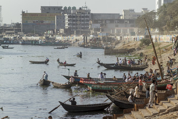 Fototapeta na wymiar Dhaka / Bangladesh - November 2012: People are working in port of Dhaka during rush hours.