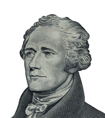 Alexander Hamilton face on US ten or 10 dollars bill macro united states money closeup on white...