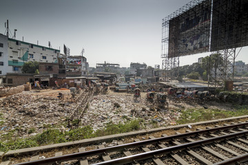 Dhaka / Bangladesh - November 2012: People live in slums just off the tracks in Dhaka Bangladesh.