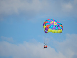 Couple flying high hang gliding 