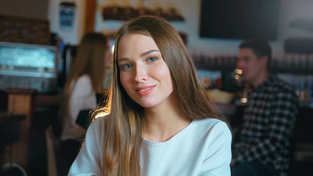 Portrait of attractive smiling young woman in restaurant