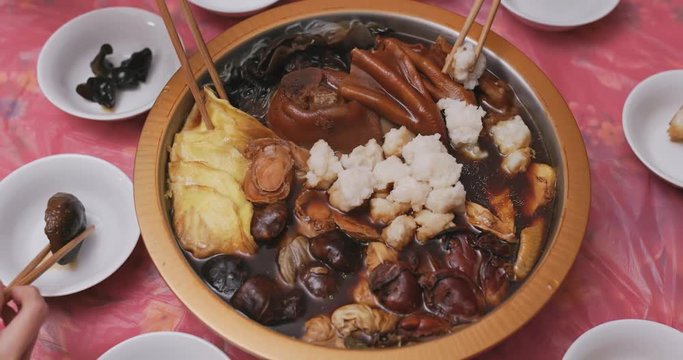 Family eating Poon choi together at home