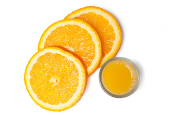 Orange juice glass and orange slices on a white background