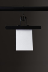 Blank Paper Hanging from Balck Hanger