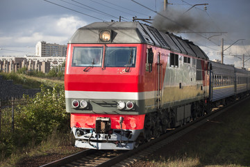 Fototapeta na wymiar Heavy locomotive on railway in the city close up.