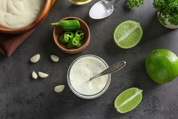 Tasty creamy lime sauce for fish taco in glass jar on kitchen table