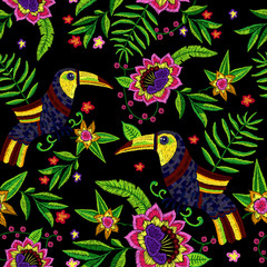 Embroidery tropical seamless pattern with exotic flowers and toucans. Vector embroidered floral illustration with bird for clothing design.