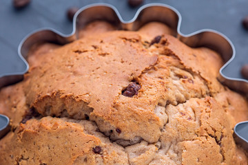 Big muffin in steel mold with coffe seeds close-up