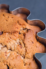 Big muffin in steel mold close-up