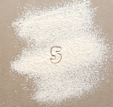 Silhouette of figure 5 on scattered flour