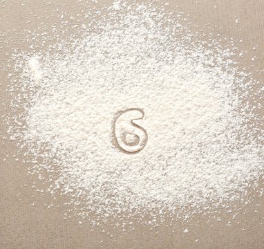 Silhouette of figure 6 on scattered flour