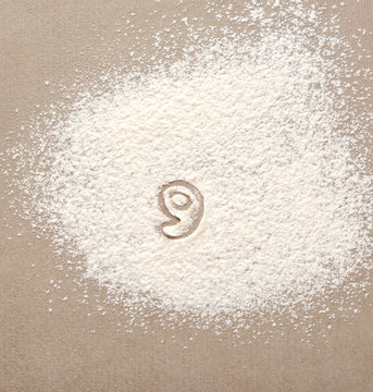 Silhouette of figure 9 on scattered flour