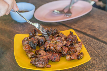 Cutlery with grilled chicken in a dish