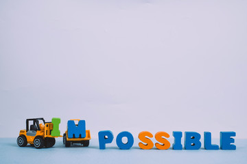 Mini forklift and bulldozer truck loading text IM changing impossible to possible text, business...
