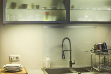 close-up of a stainless steel kitchen sink and modern faucet