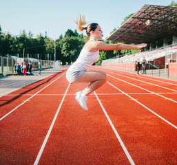 Fototapeta premium A young girl warms up on a treadmill before the competition