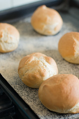 Baked traditional German Kaiser rolls or Austrian Vienna rolls homemade from yeast dough with white wheat flour on flour dusted baking sheet after baking