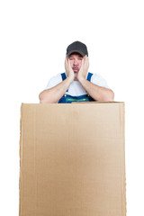 Tired delivery man leaning against large package