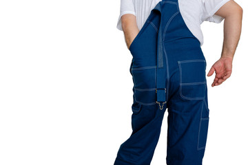 Workman in dungarees with his hand inside