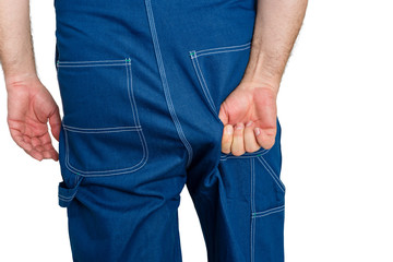 Workman in denim dungarees tugging at the fabric