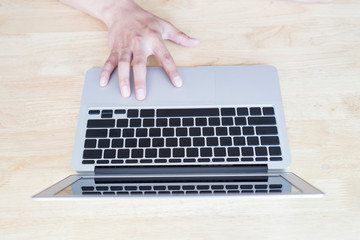 man working with laptop, man's hands on notebook computer, business person at workplace