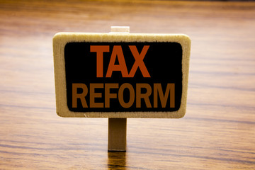 Conceptual hand writing text caption inspiration showing Tax Reform. Business concept for Government Change in Taxes written on announcement board on the wooden wood background.