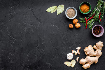 Gastronomy, culinary. Secrets of tasty dishes. Seasoning and spices. Rosemary, ginger, chili pepper on black background top view copy space