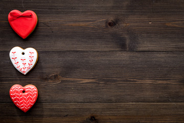 Fototapeta premium St Valentine's Day cookies in shape of heart on dark wooden background top view copy space
