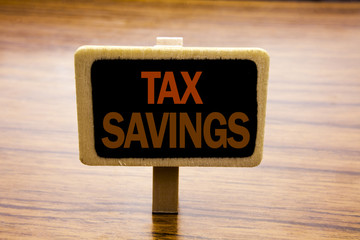 Conceptual hand writing text caption inspiration showing Tex Savings . Business concept for Tax Savings Extra Money Refund written on announcement board on the wooden wood background.