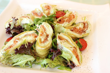 pancakes with salmon and feta cheese decorated with greenery