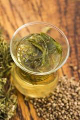 Cannabis herbal tea on wooden background