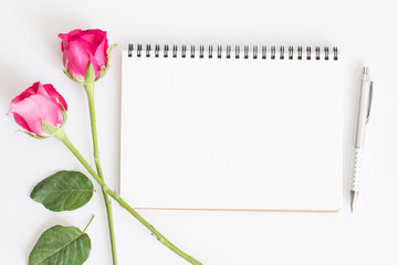 Blank notebook with pink roses and pen on white background,Flat lay photo of a notebook for your message,Valentine's Day concept
