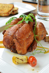 Roasted spring chicken  with broccoli, tomatoes and other garnishes.                             
