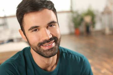 Fototapeta premium Young bearded man in casual clothes indoors