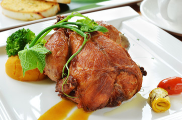 Roasted spring chicken  with broccoli, tomatoes and other garnishes.                             
