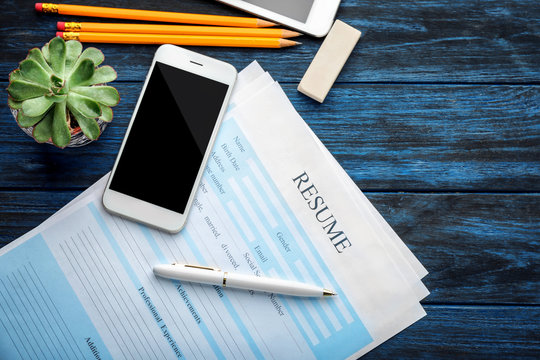 Resume forms with phone on table. Job interview concept