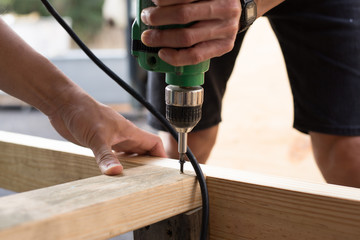 man worker working with an electric drill