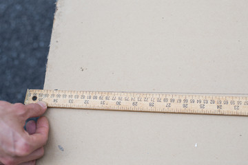 builder with yellow tape measure