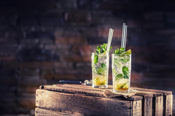 Mojito. Alcoholic cocktail drink mojito on wooden board in pub or sestaurant