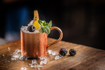 Moscow mule cocktail alcoholic drink on bar counter in pub or restaurant.