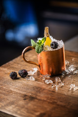 Moscow mule cocktail alcoholic drink on bar counter in pub or restaurant.